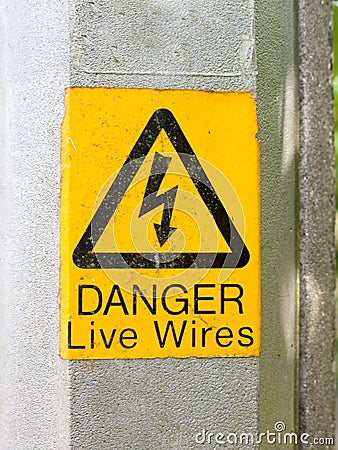 Yellow electrical lamp post warning sign Stock Photo
