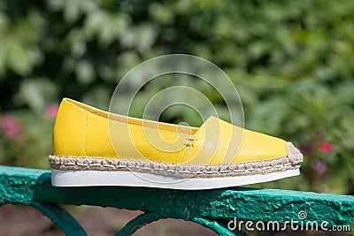Yellow espadrilles on a background of green grass Stock Photo
