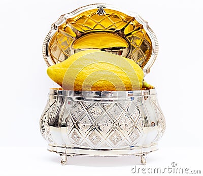 Yellow etrog for Sukkot With a silver box Stock Photo