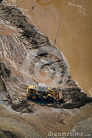 Yellow Excavator cleans up the silt in the Yangtze River Editorial Stock Photo