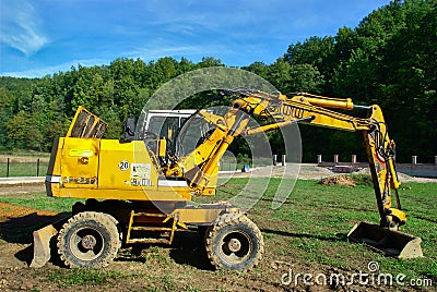 Yellow Excavator at Work Editorial Stock Photo