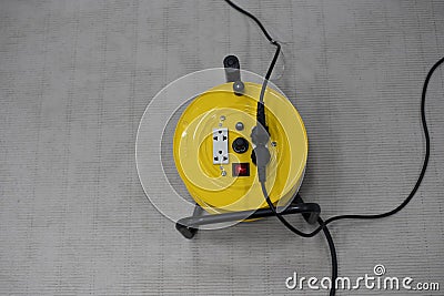 Yellow extension cord wheel Neutral cable connector Stock Photo