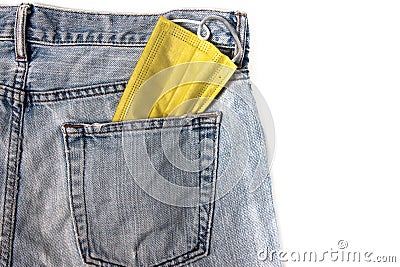 Yellow face mask That is in the back pocket jeans Stock Photo