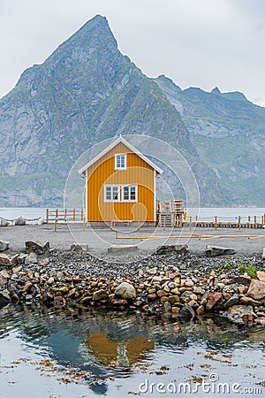 A yellow fishing cabin in SakrisÃ¸y, Norway Stock Photo
