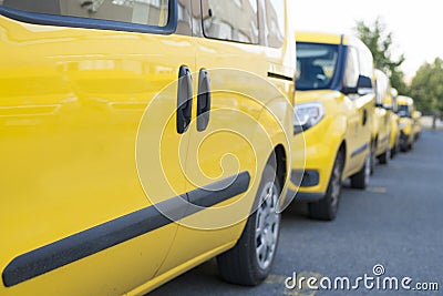 Yellow fleet cars parked in a line. Lined up pick-ups cars. Stock Photo