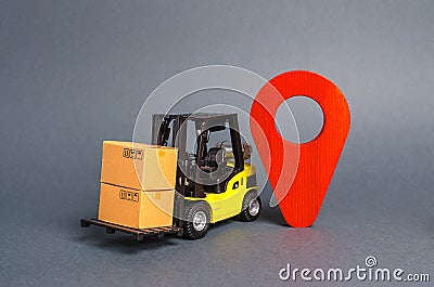 Yellow forklift carries boxes and a red location pointer. Transportation services and logistics management in production warehouse Stock Photo