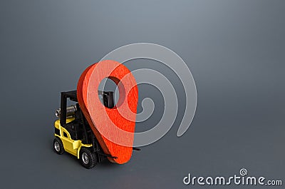 Yellow forklift carries a red location pin pointer. Transportation services and logistics, warehouse management. Real-time Stock Photo