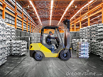 Yellow forklift lift aluminum pack stack inside warehouse. Material handling, storage and transportation concept. Stock Photo