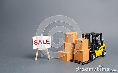 Yellow Forklift truck with cardboard boxes and stand with the word sale. sale of goods, big discounts on goods of the outgoing Stock Photo