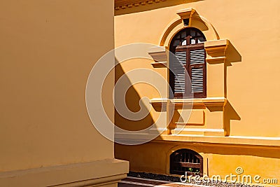 Yellow French Colonial building facade and window frame of Udon Thani city museum, Thailand Stock Photo