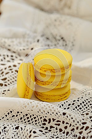 Yellow French macaron on vintage doily Stock Photo