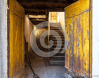 Yellow front door in an old dilapidated house Stock Photo