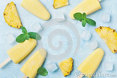 Yellow frozen fruit popsicles or homemade ice cream of pineapple top view. Summer food. Stock Photo