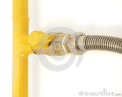 Yellow gas pipe with a valve. White background Stock Photo