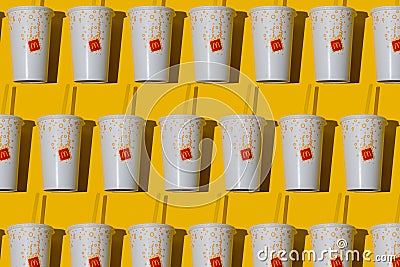 Yellow glass of McDonald's. Paper cup with lid. Takeaway drink. McDonald's logo. McCafe cup shadow top view Editorial Stock Photo
