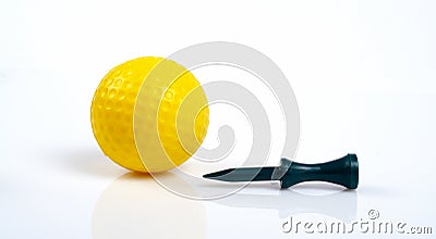 Yellow golfball and green tee with reflecting Stock Photo