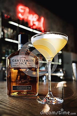 Yellow gourmet cocktail with gentleman jack whiskey on the bar Editorial Stock Photo