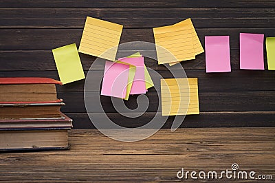 Yellow, green, pink reminder notes on a wooden board, empty space for text Stock Photo