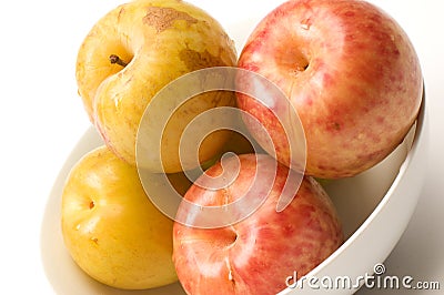 Yellow green sweetie and red pluot fruits Stock Photo