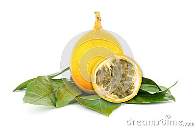 yellow Grenadilla oval fruit on a green leaf substrate, an exotic fruit with a fragrant filling Stock Photo
