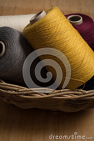 Yellow, Grey, Red, and White Thread in Basket Stock Photo