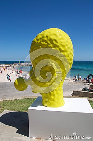 Yellow Head Sculpture: Blowing Bubble in Profile Editorial Stock Photo