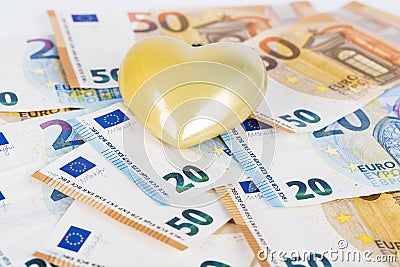 Yellow heart with Euro. euro banknotes. love and money Stock Photo
