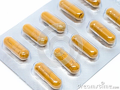 Yellow herb pills transparent gelatin capsule in blister pack Stock Photo