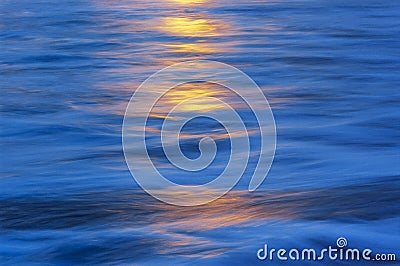 Yellow highlights on blue water Stock Photo