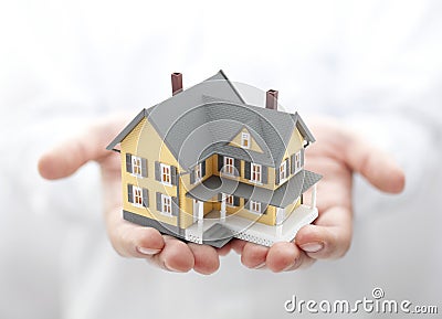 Yellow house in hands Stock Photo