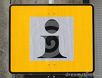 The yellow information sign in the rainy street Stock Photo