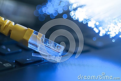 Yellow internet connection cable on laptop. Stock Photo