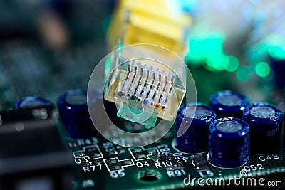 Yellow internet switch on computer circuit board , glowing optical fibres Stock Photo