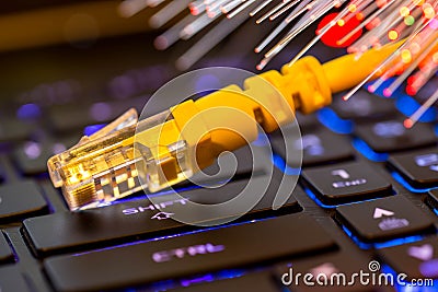 Yellow internet switch on gaming laptops RGB keyboard, glowing optical fibres Stock Photo