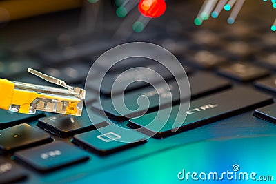 Yellow internet switch on gaming laptops RGB keyboard, glowing optical fibres Stock Photo