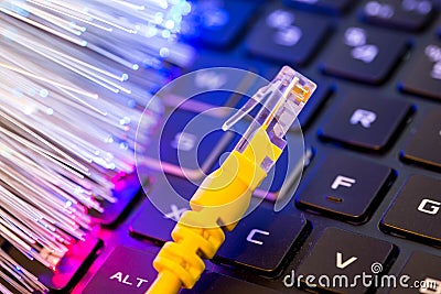 Yellow internet switch on gaming laptops RGB keyboard, glowing optical fibres Stock Photo