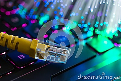 Yellow internet switch on rgb gaming laptop keyboard, glowing optical fibres Stock Photo