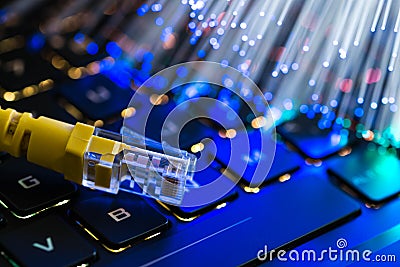 Yellow internet switch on rgb gaming laptop keyboard, glowing optical fibres Stock Photo