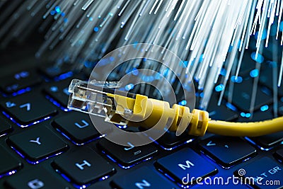 Yellow internet switch on rgb gaming laptop keyboard, glowing optical fibres Stock Photo