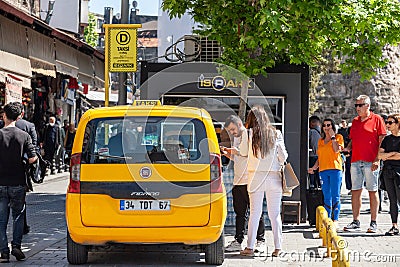 Yellow istanbul taxi in the middle of a street in istanbul, ready for a ride and a transfer in cab Editorial Stock Photo