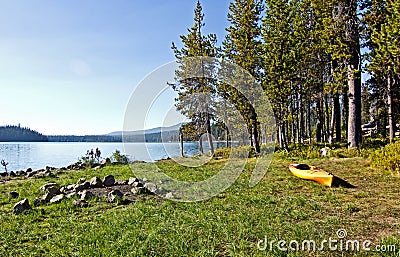 Yellow Kayak on Banks of Grassy Lake Stock Photo