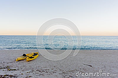 Yellow kayaks on a sandy beach Stock Photo