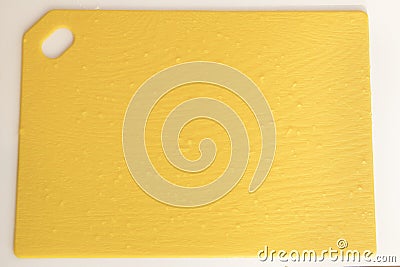 Yellow kitchen cutboard with waterdrops close up for background Stock Photo