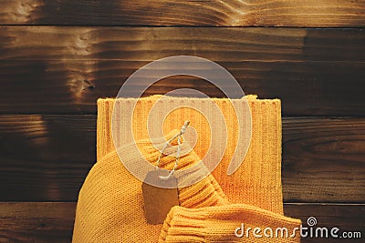 Yellow knitted sweater on old wooden background top view. Fashion Lady Clothes Set Trendy Cozy Knit. Stock Photo