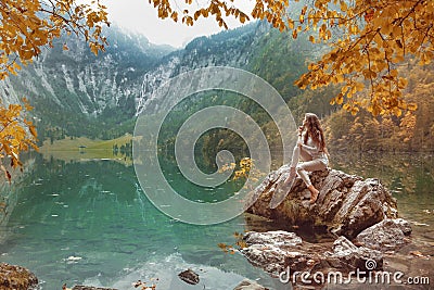 Yellow leaves over Obersee Lake autumn landscape. Young tourist Stock Photo