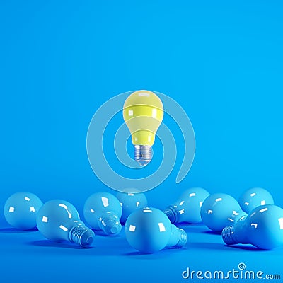 Yellow light bulb floating among blue light bulbs on background. Stock Photo