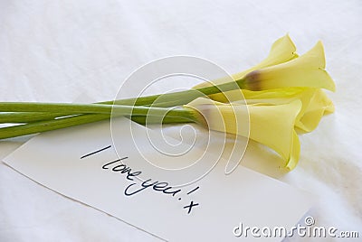 Yellow lillies and love note Stock Photo