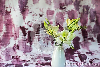 Yellow lisianthus fflower in vase on violet background Stock Photo