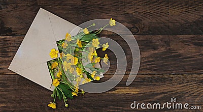 yellow Little field flowers in Envelope Rustic Wooden Background Banner Flat Lay Stock Photo