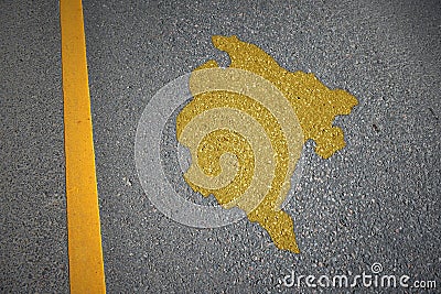 yellow map of montenegro country on asphalt road near yellow line Stock Photo